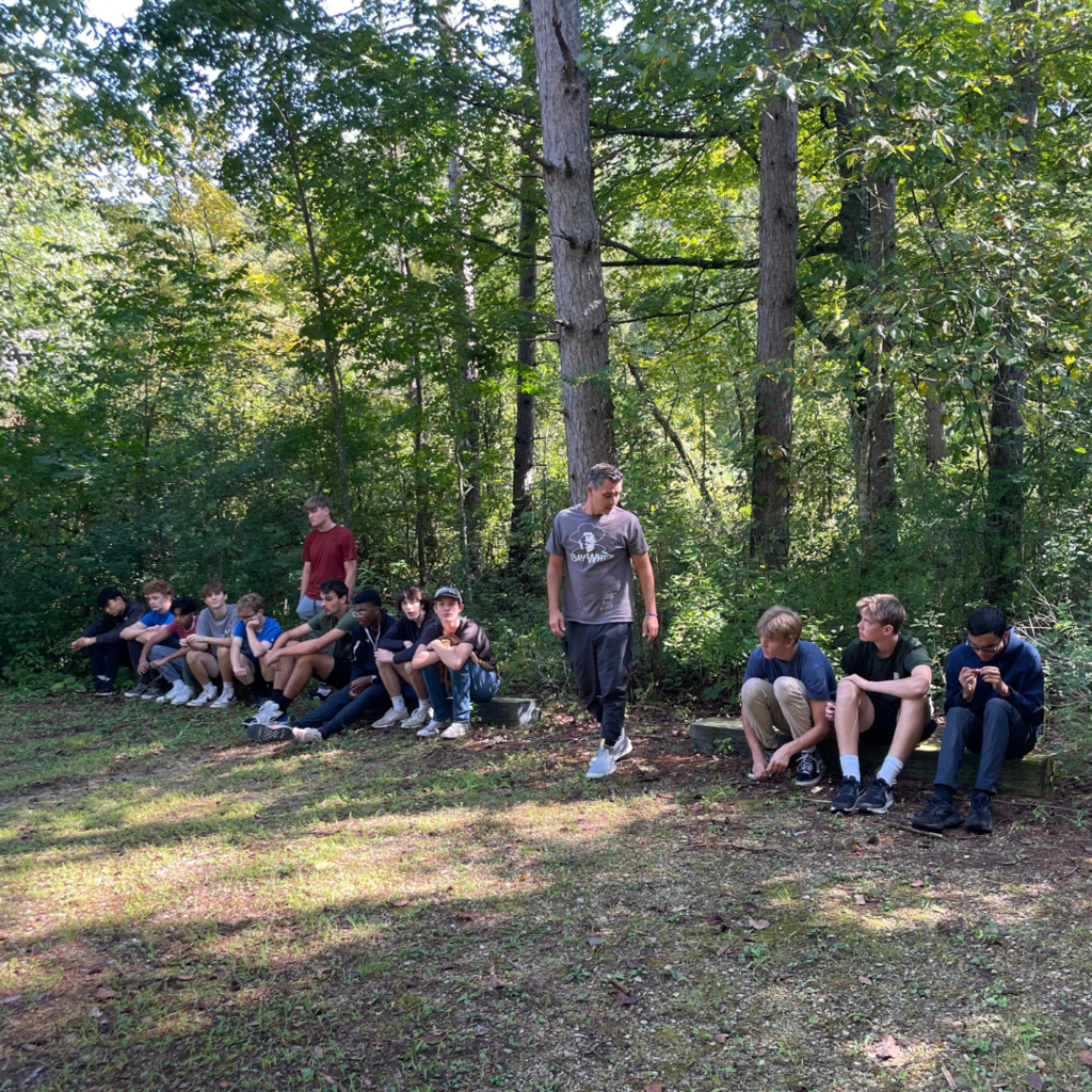 group of hi school boys sitting on benches