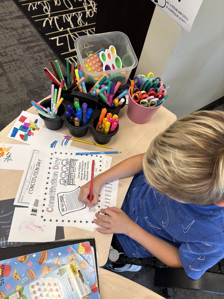 3rd grade student working on a coloring sheet