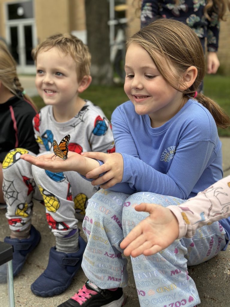 kindergarten students releasing butterflies