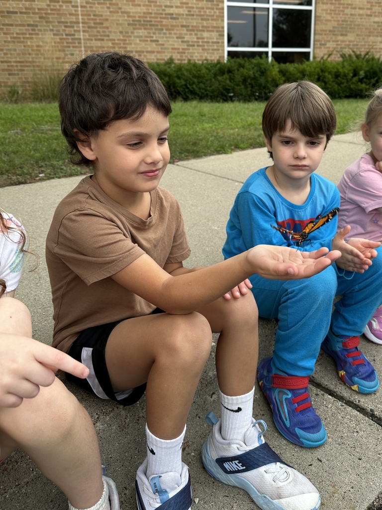 kindergarten students releasing butterflies
