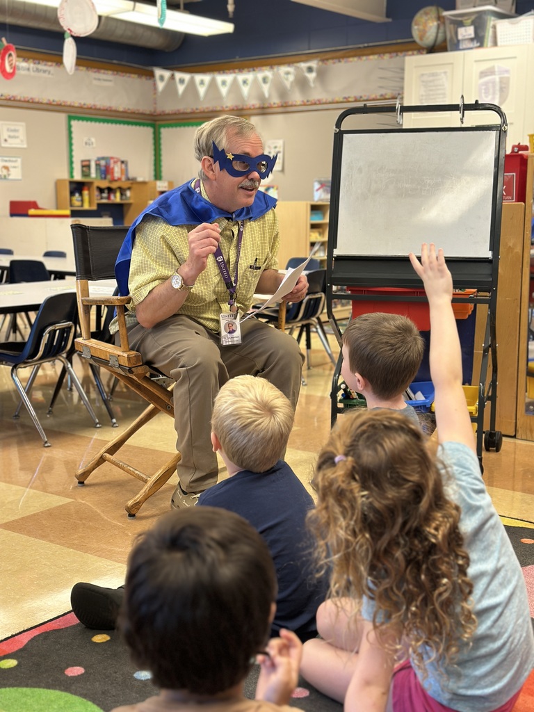 elementary principal reading to the kindergarten students