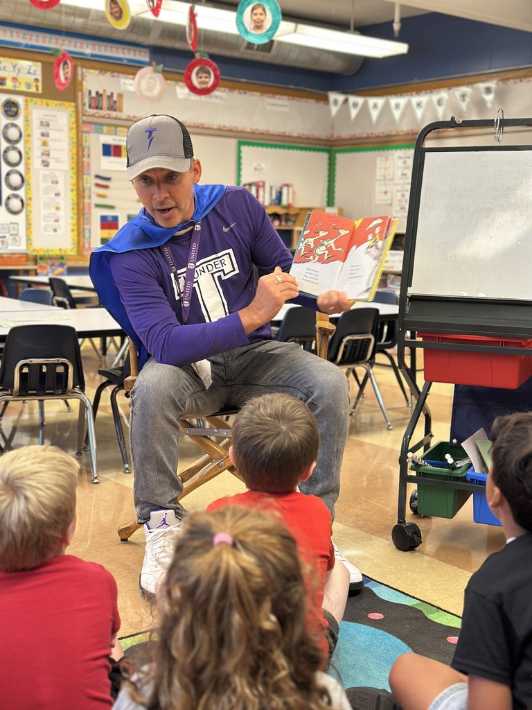 head of school reading to the kindergarten students