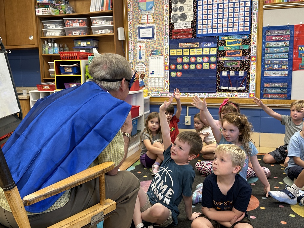 elementary principal reading to the kindergarten students