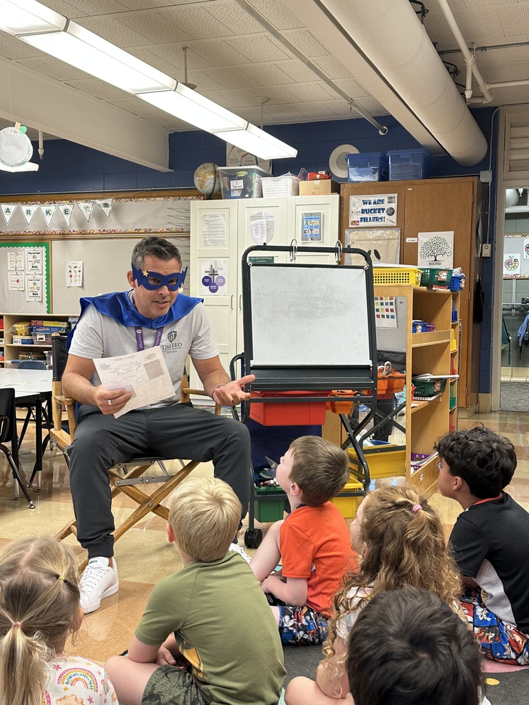 head of school reading to the kindergarten students