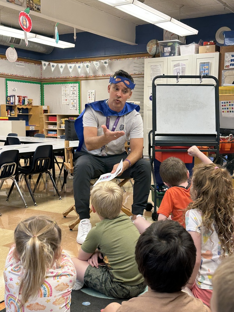 head of school reading to the kindergarten students