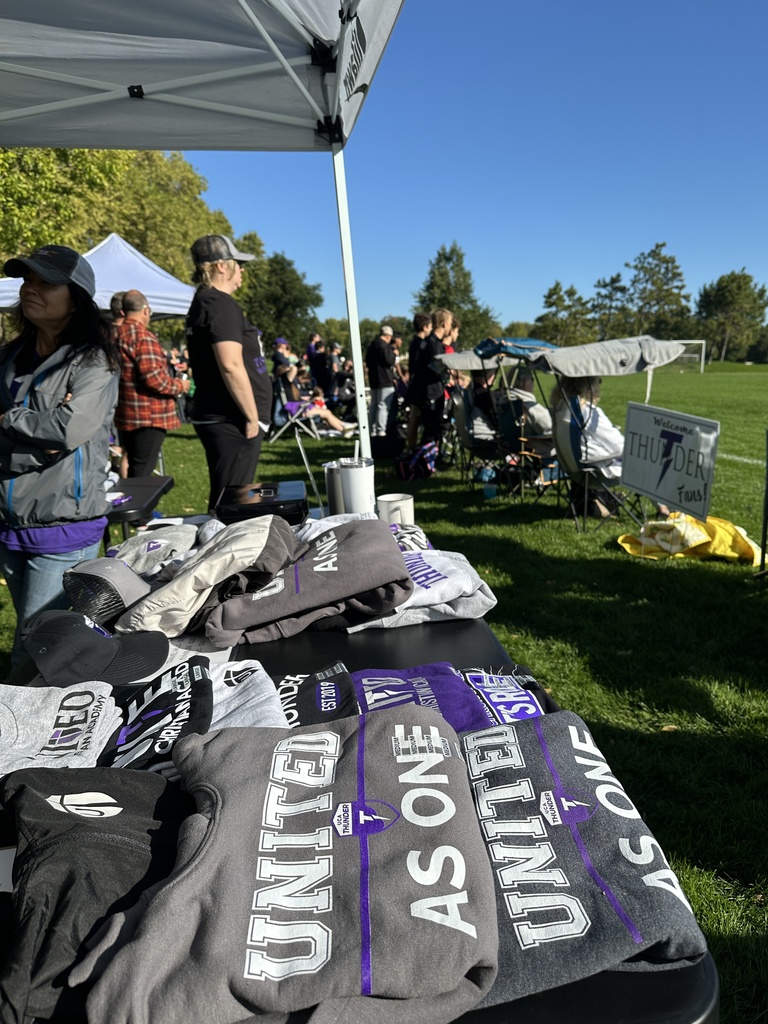 table of apparel for sale at a soccer game
