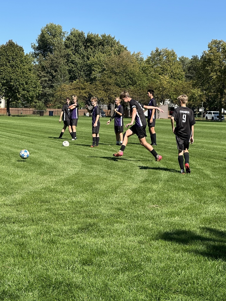 varsity boys soccer players warming up before a game