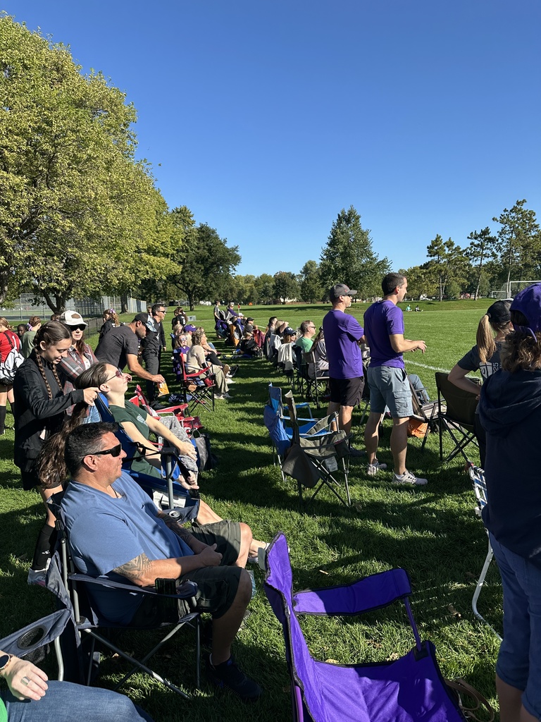 fans along the sideline of a soccer game