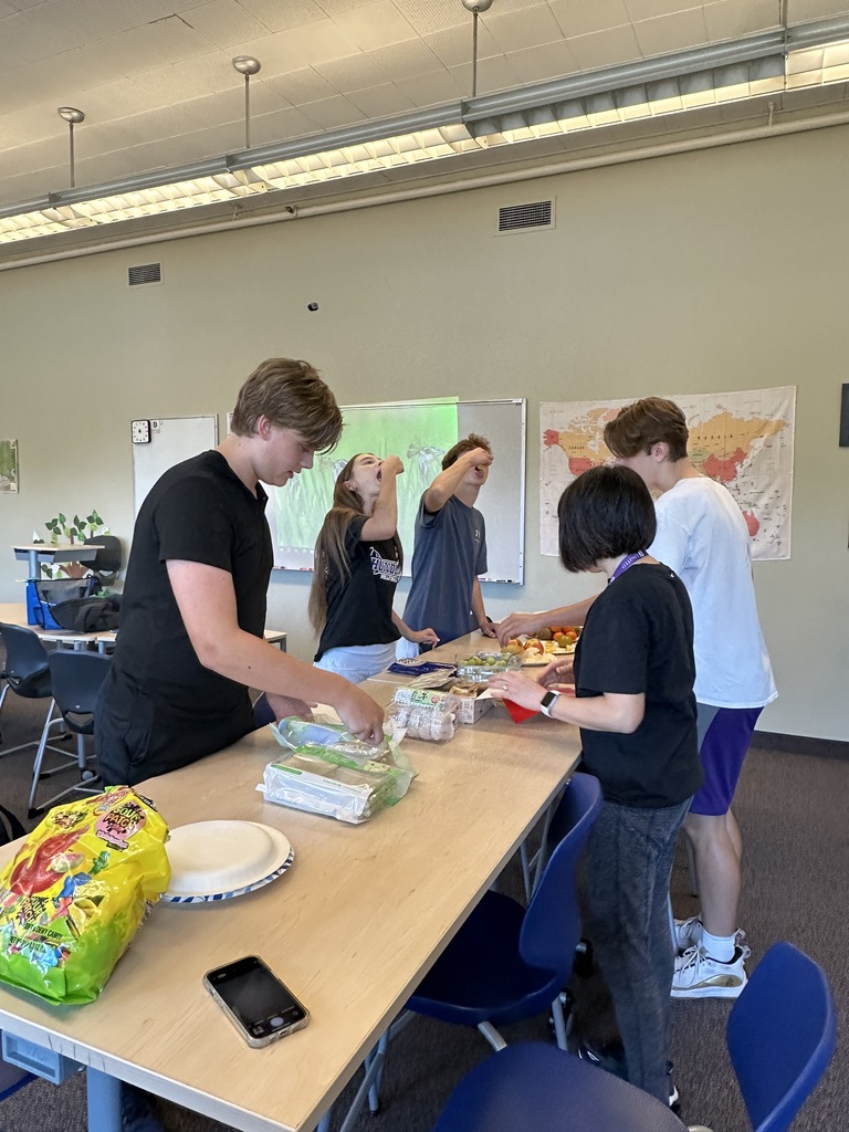 Chinese teacher showing different cultural foods to her students
