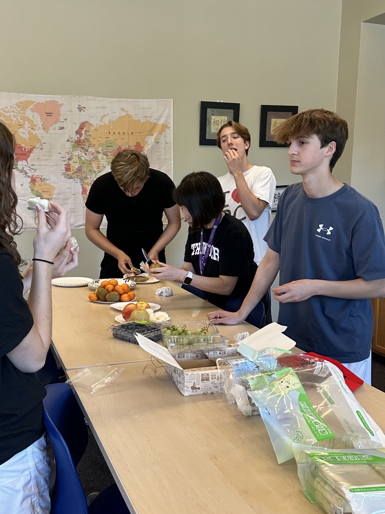 Chinese teacher showing different cultural foods to her students