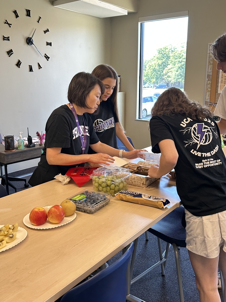 Chinese teacher showing different cultural foods to her students