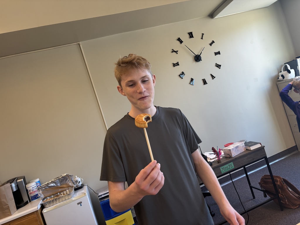 student holding a chinese dessert cake on a chopstick