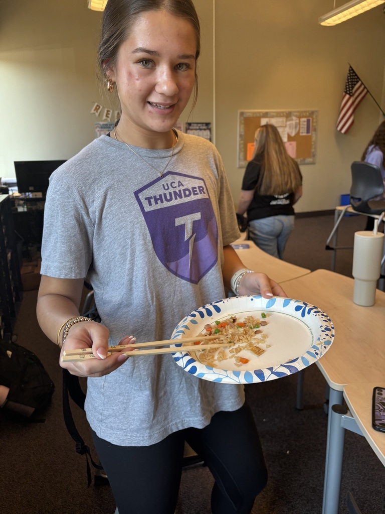 student eating fried rice with chopsticks