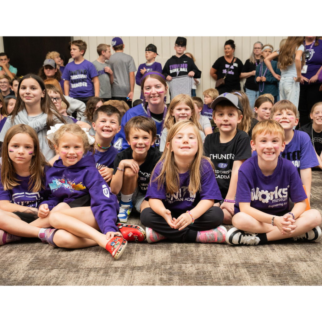 younger students cheering at a pep fest