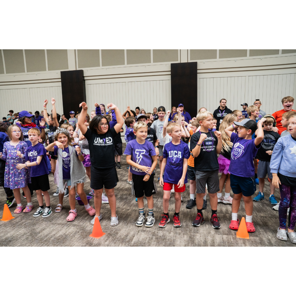 younger students cheering at a pep fest