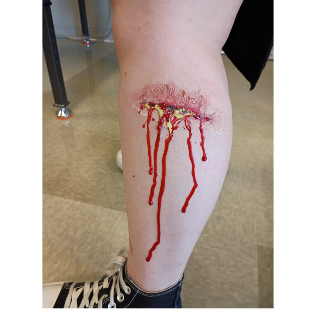 fake laceration on a student's leg