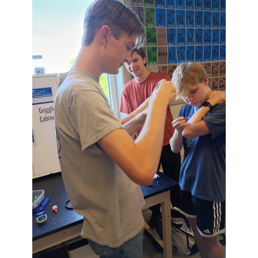 students applying make-up to look like and injury