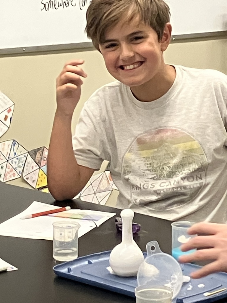 students doing a science experiment to mimic a volcanic eruption