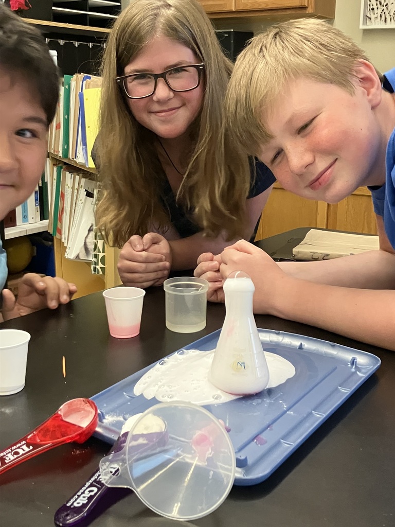 students doing a science experiment to mimic a volcanic eruption