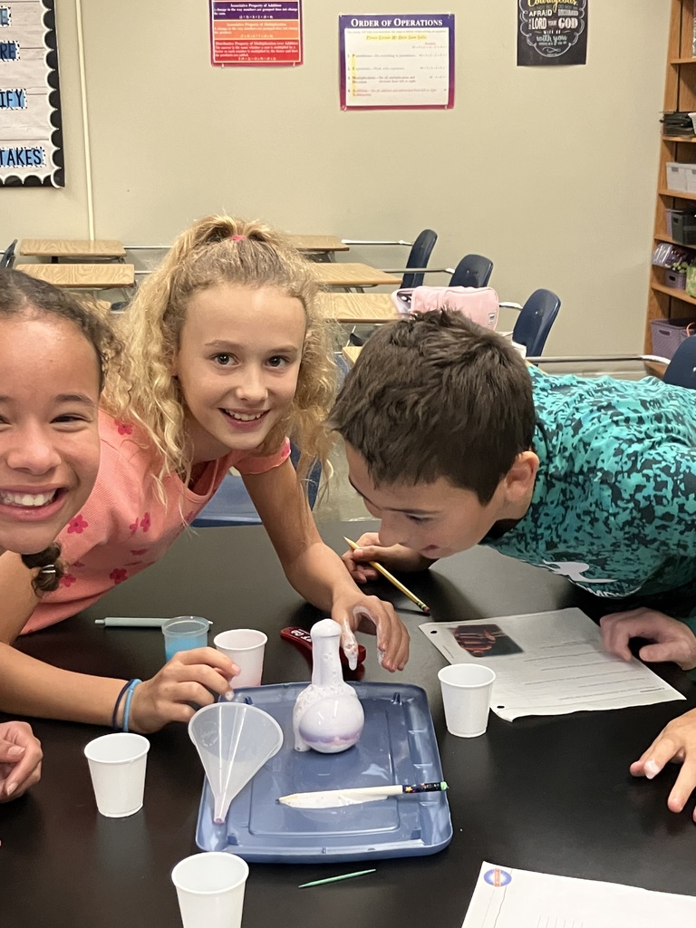 students doing a science experiment to mimic a volcanic eruption