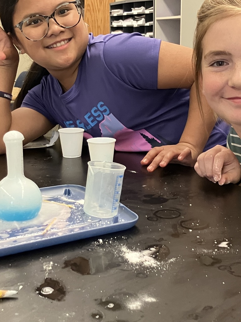students doing a science experiment to mimic a volcanic eruption