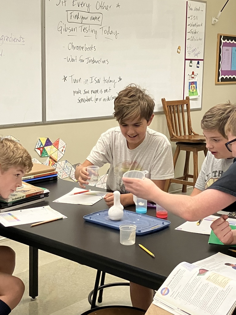 students doing a science experiment to mimic a volcanic eruption