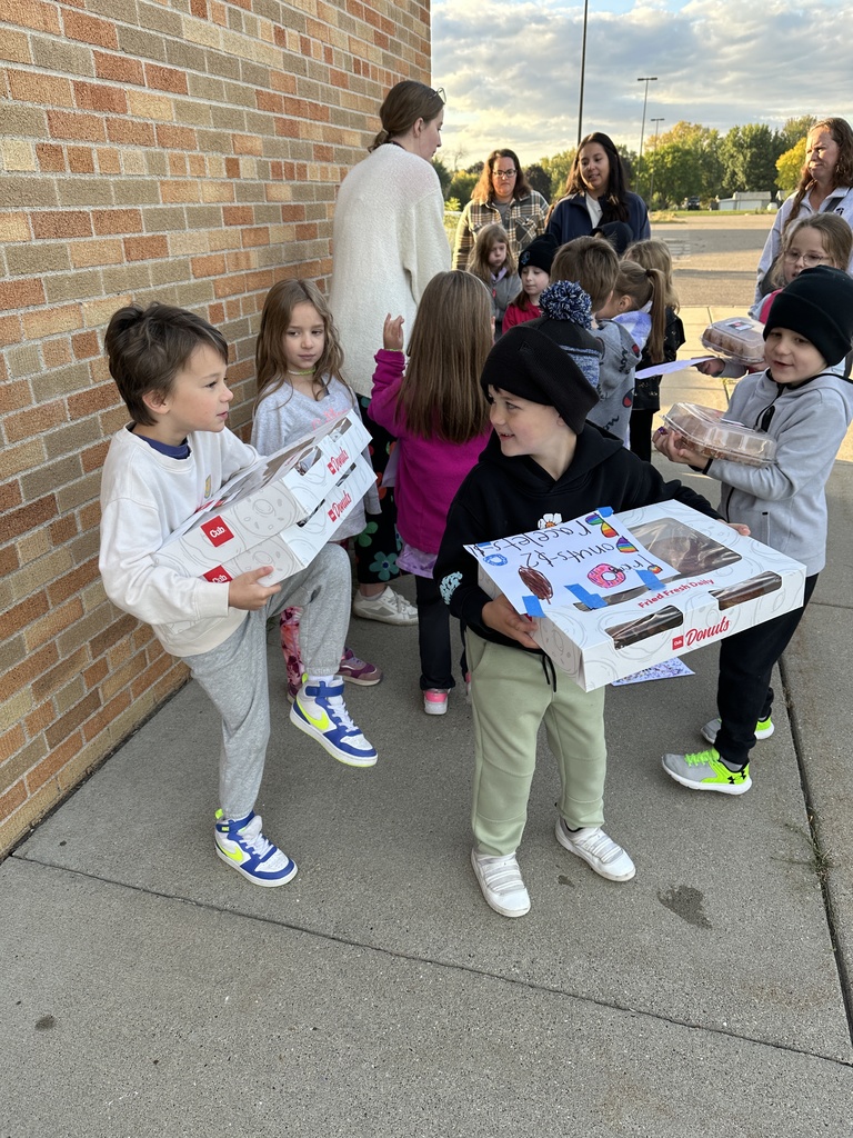 kids holding boxes of donuts