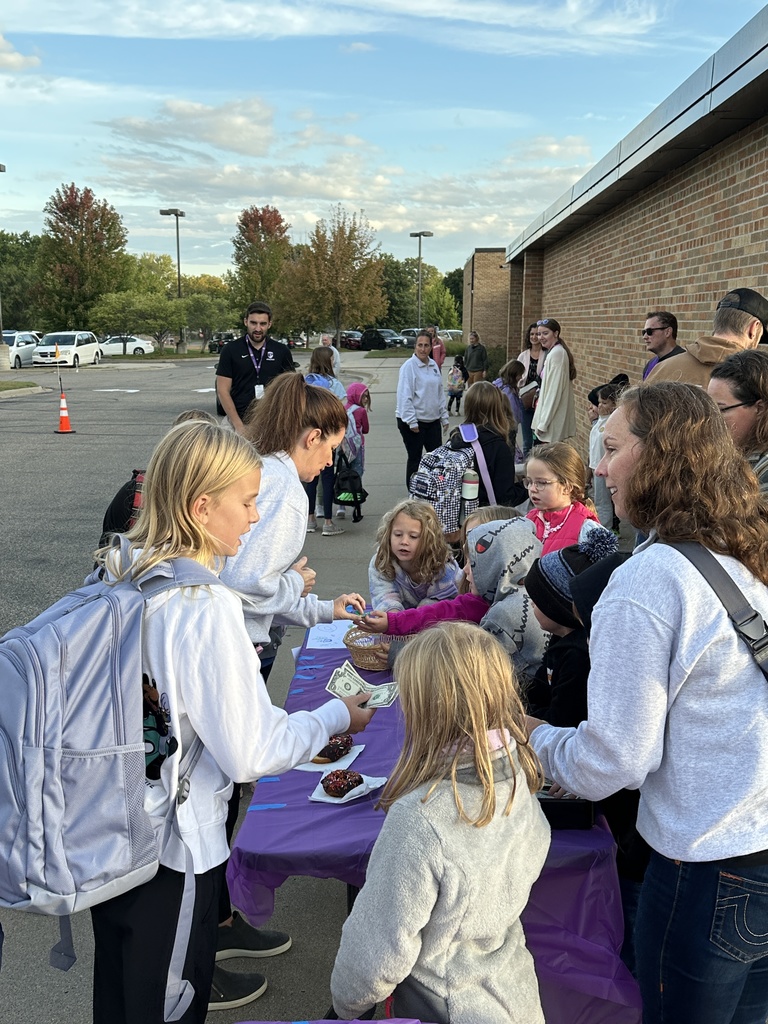 students selling donuts to other students and parents