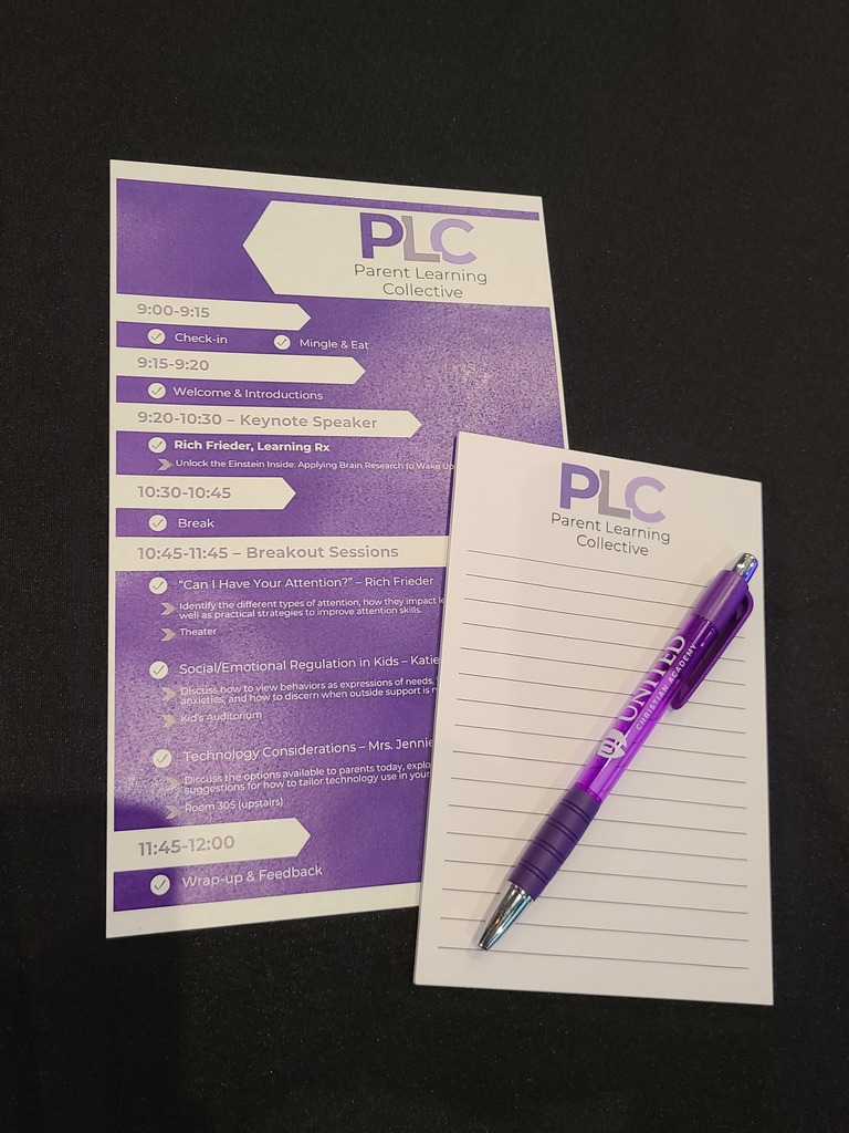 pad of paper, a pen, and an agenda sitting on a table
