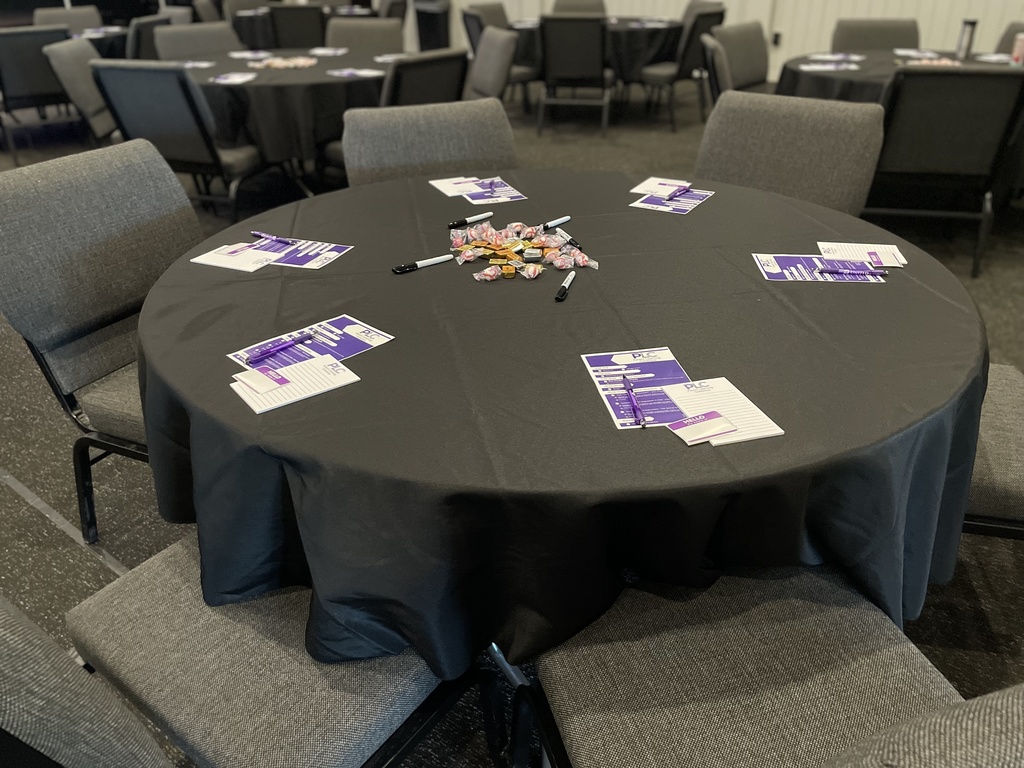 round table set with materials for parents coming to a conference