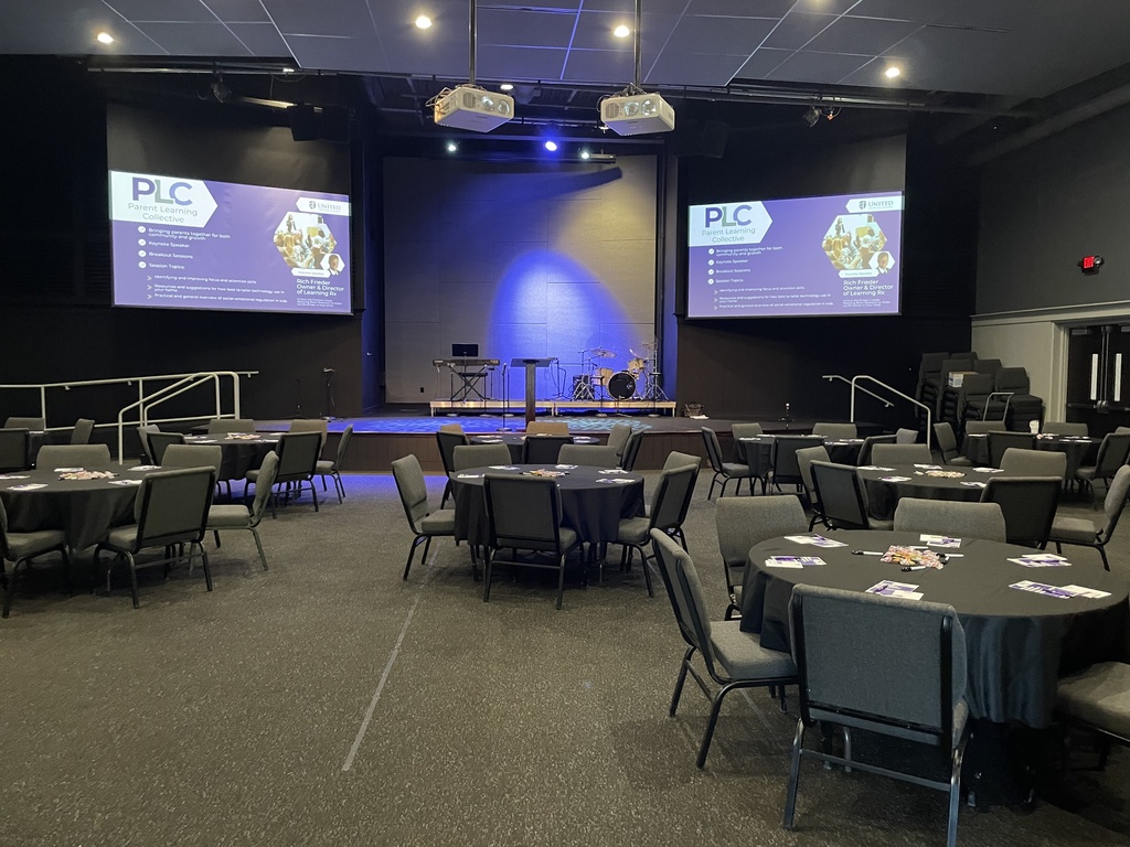 large room filled with round tables set up or a parent learning conference