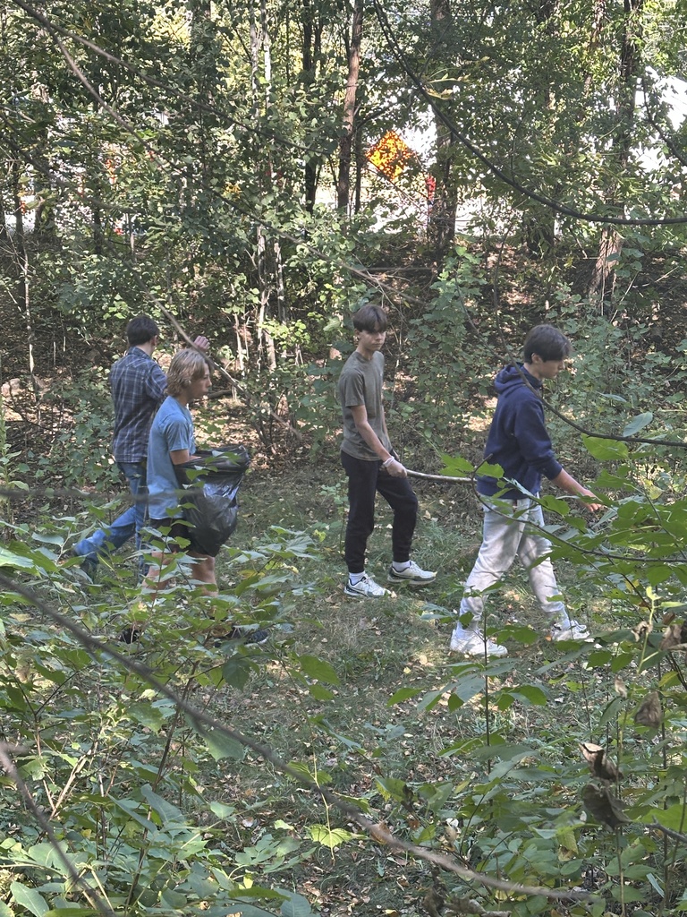 students picking up trash for a service project