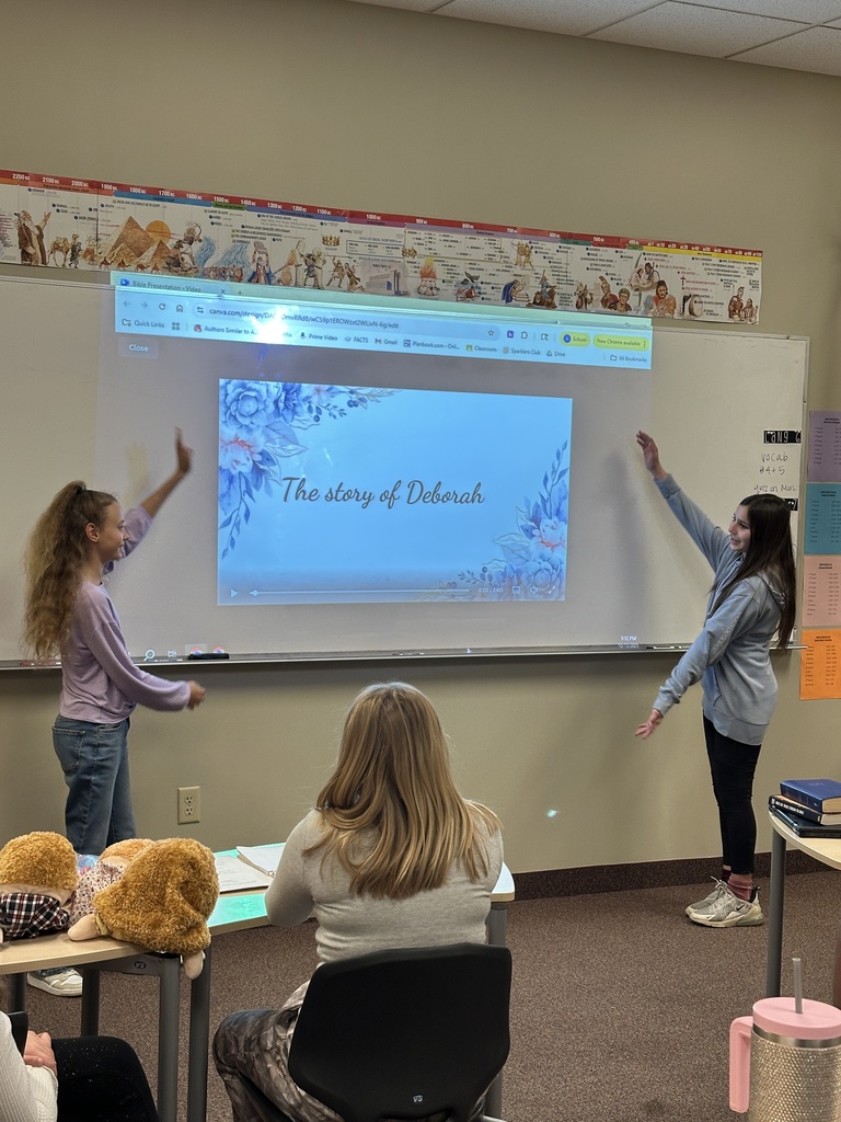 two students presenting in front of the class