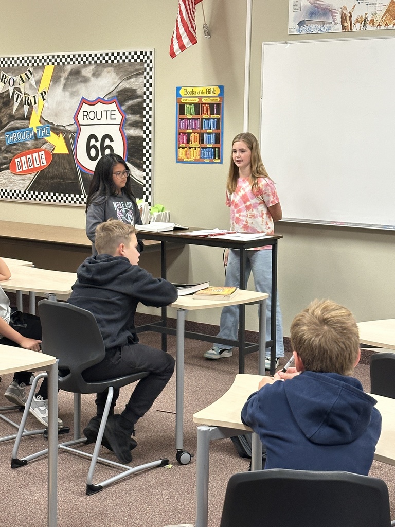 two students presenting in front of the class