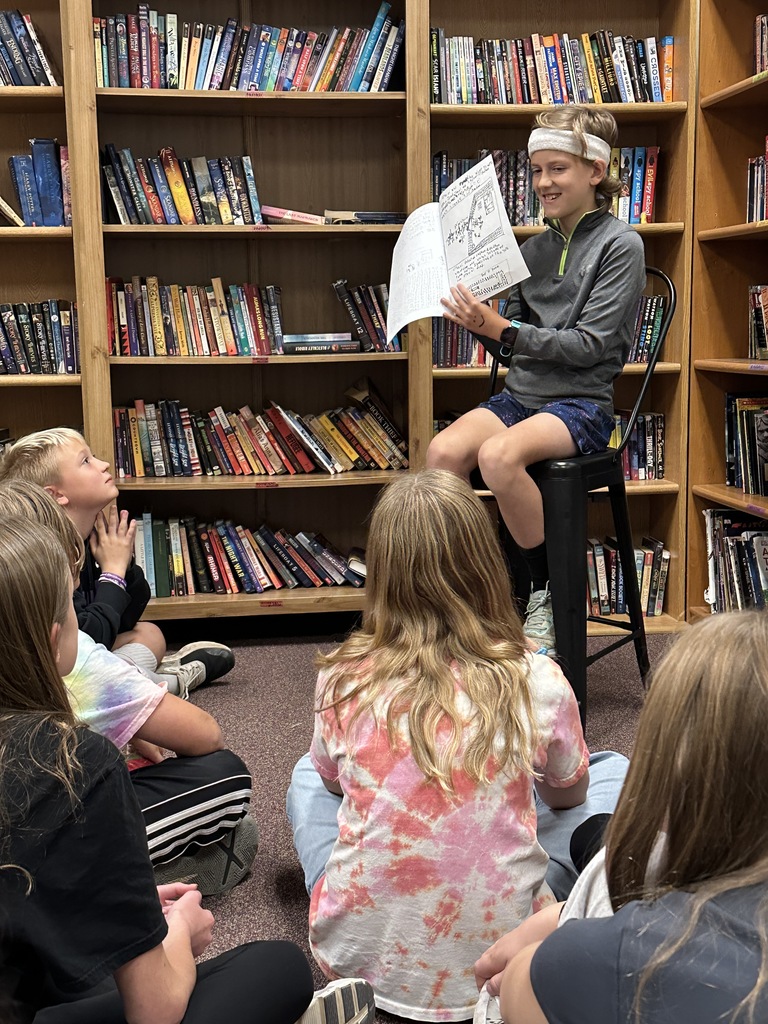student reading his story to classmates