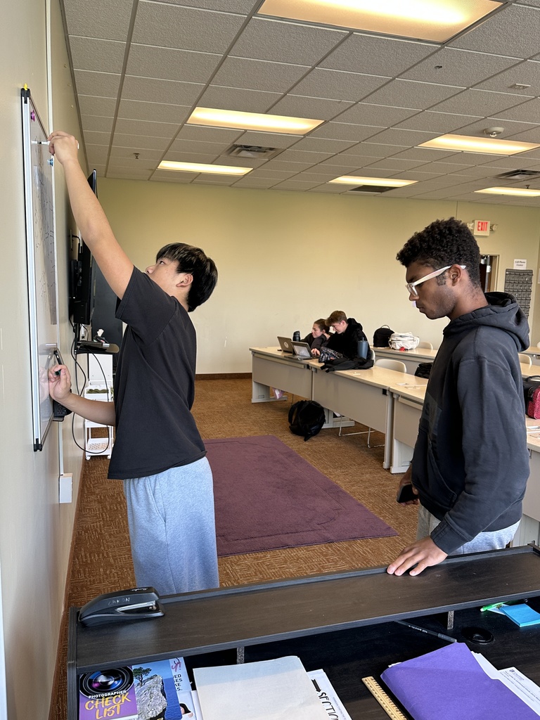 student drawing on the whiteboard