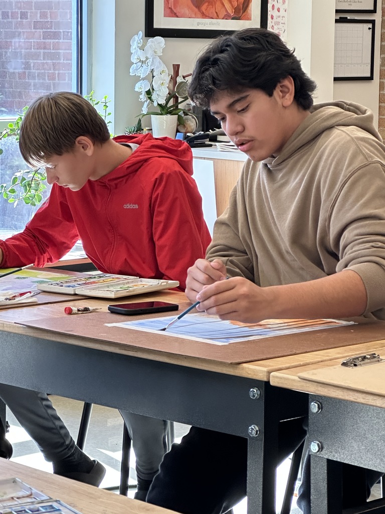 high school students doing a watercolor art project to paint fall leaves