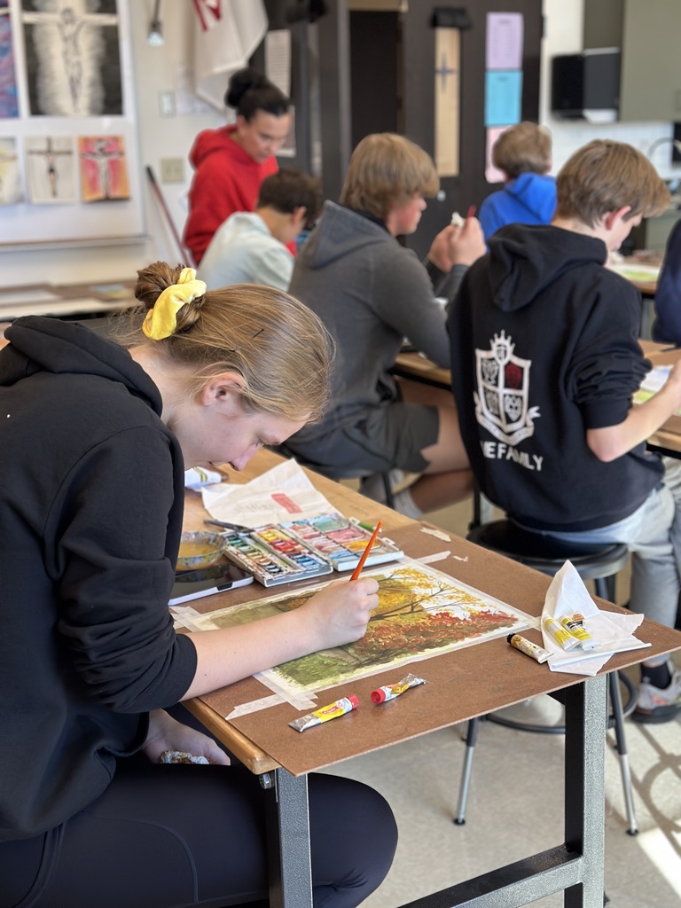 high school students doing a watercolor art project to paint fall leaves
