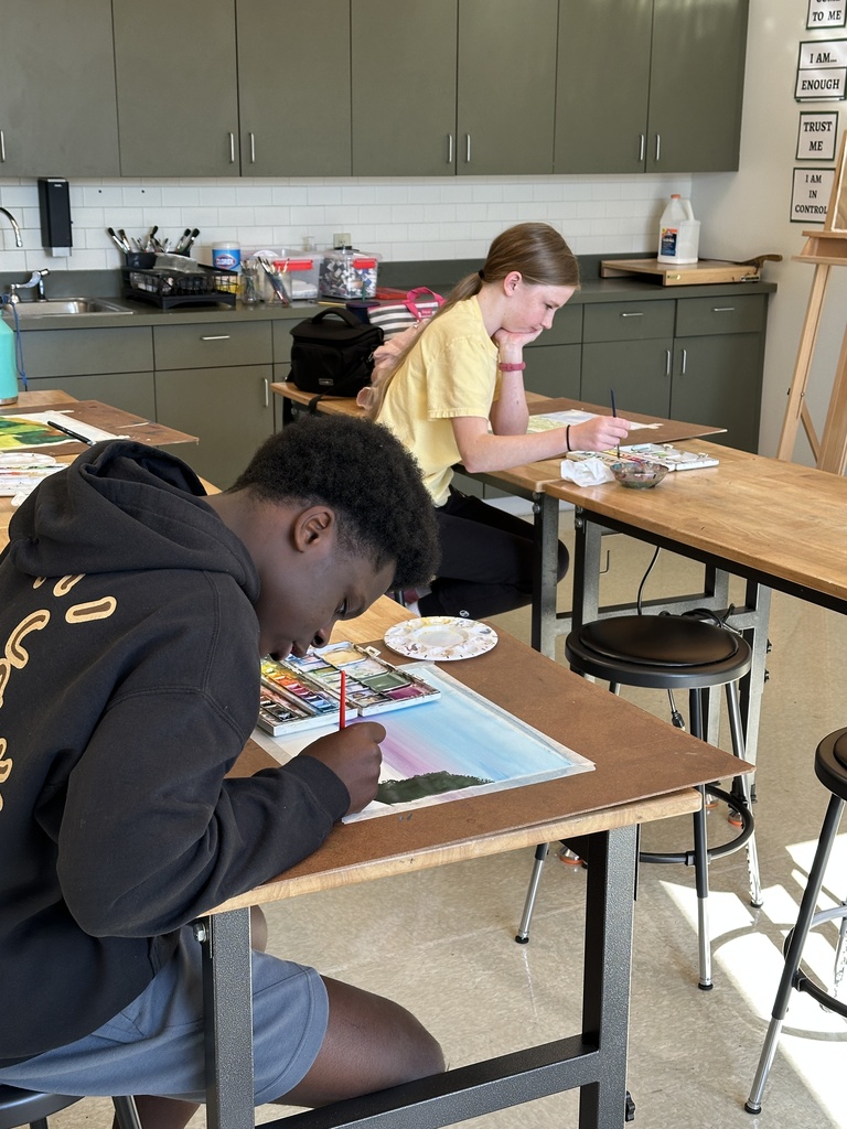 high school students doing a watercolor art project to paint fall leaves