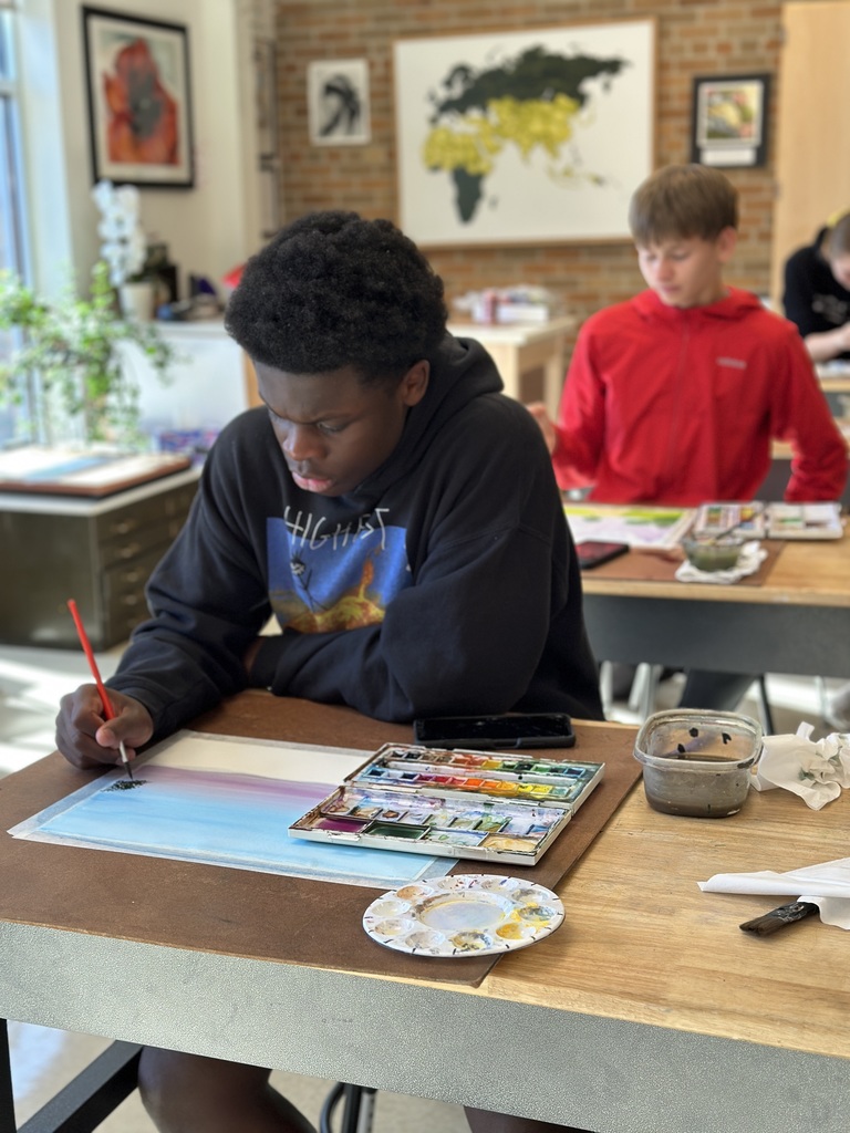 high school students doing a watercolor art project to paint fall leaves