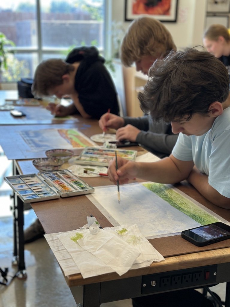 high school students doing a watercolor art project to paint fall leaves