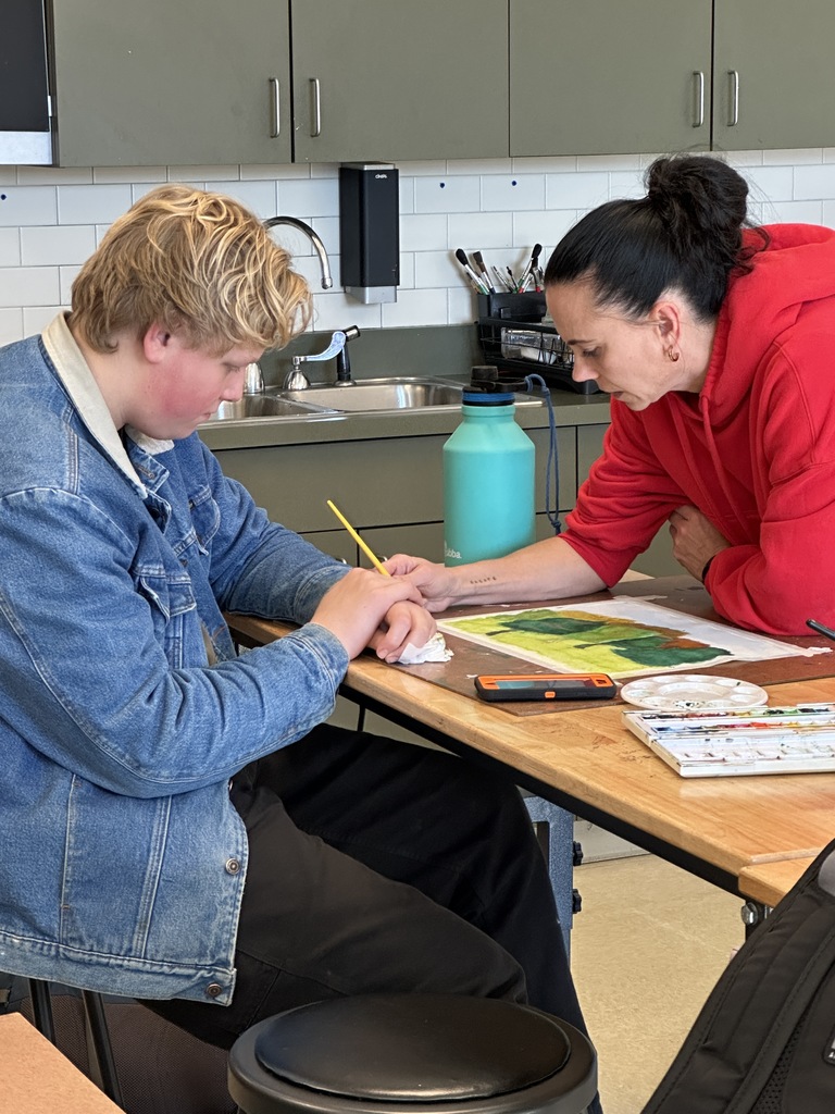 high school students doing a watercolor art project to paint fall leaves