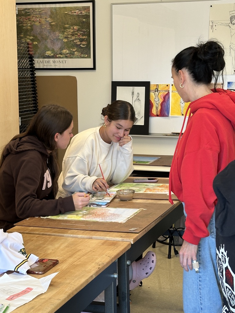 high school students doing a watercolor art project to paint fall leaves