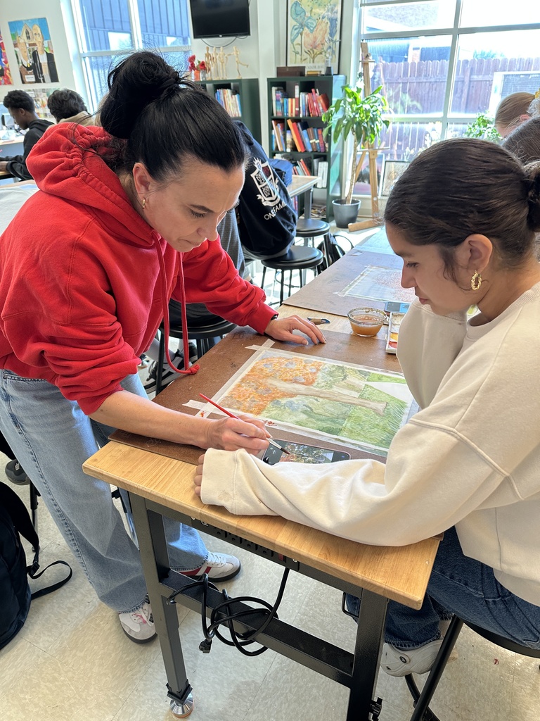 high school students doing a watercolor art project to paint fall leaves
