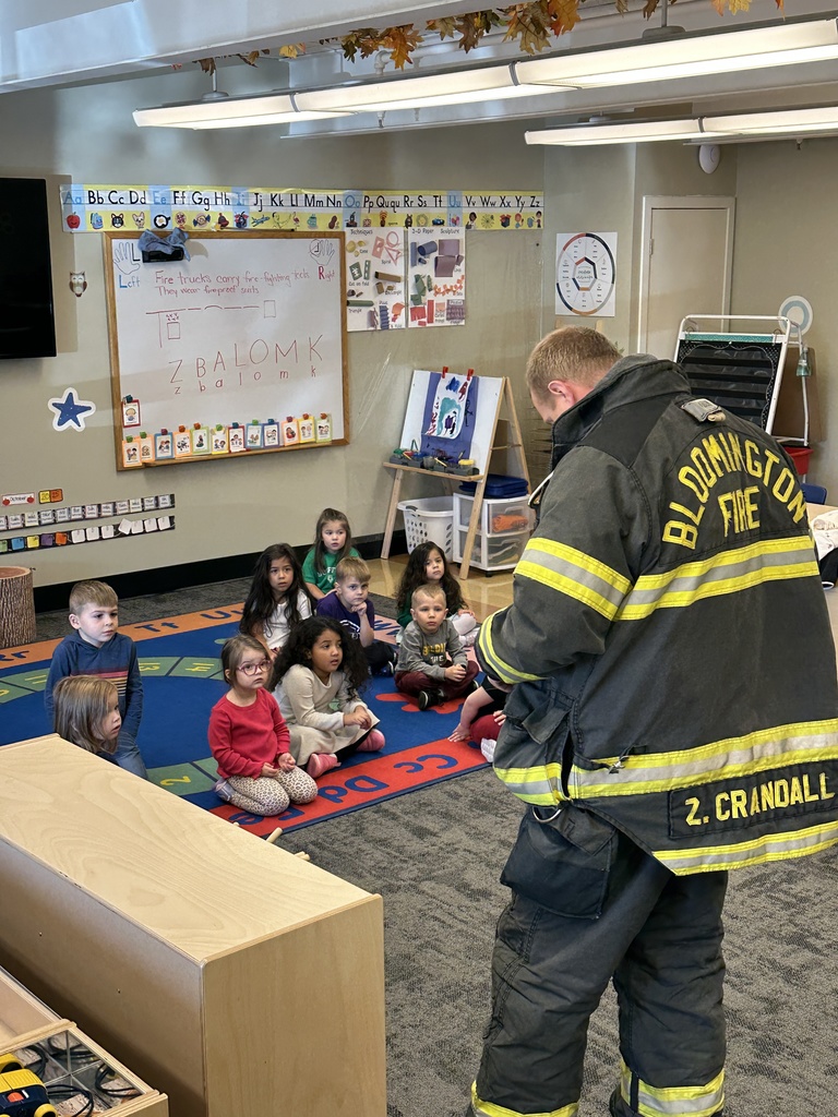 firefighter showing students his uniform
