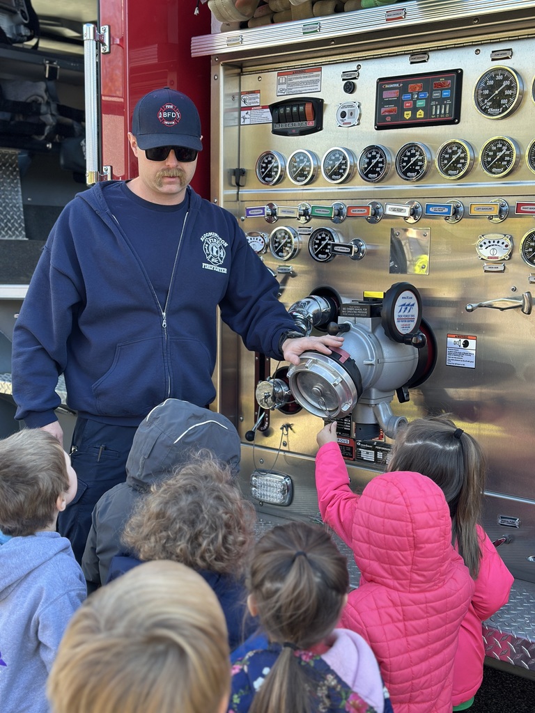 firefighters showing preK students equipment from their truck