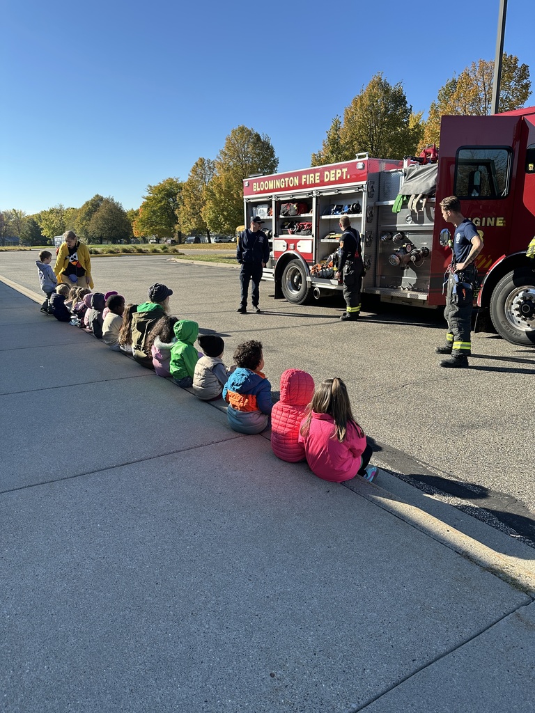 firefighters showing preK students equipment from their truck