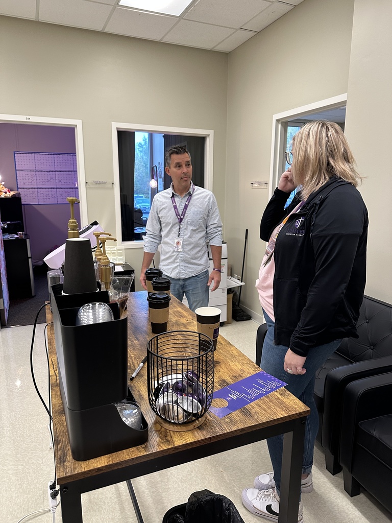 head of school and operations director standing by the coffee bar
