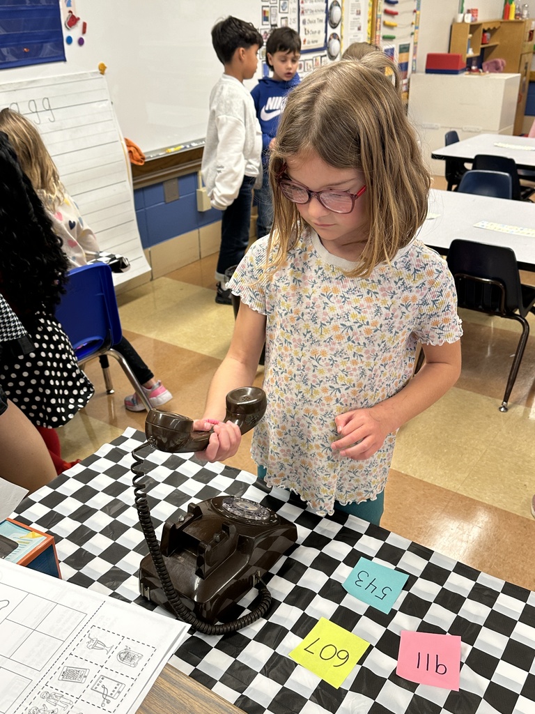 student looking at a rotary phone