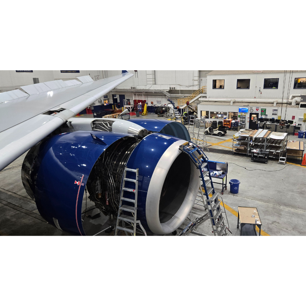 Delta airplane with an engine taken apart sitting in a maintenance hangar